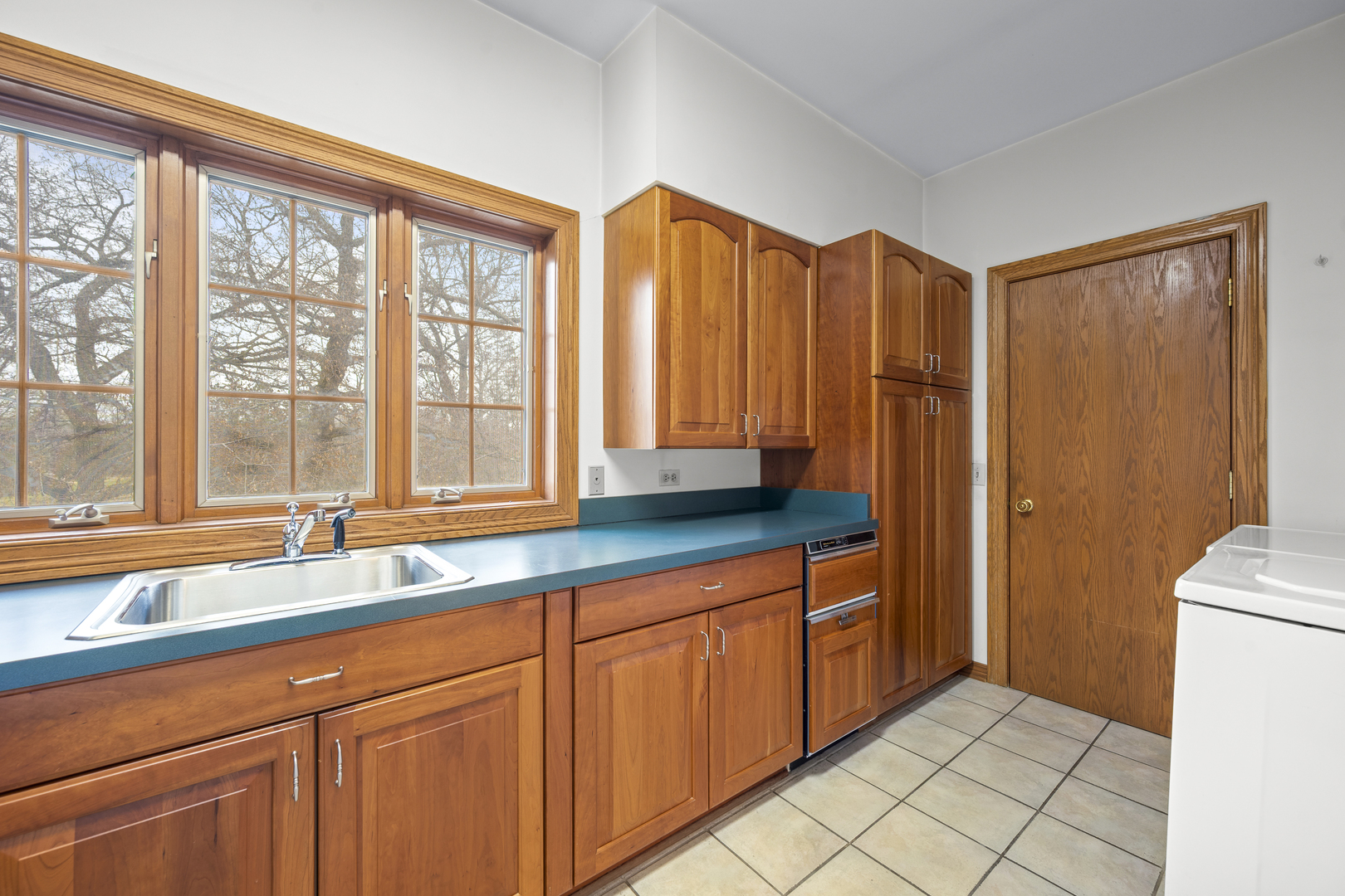 32981 North River Road Libertyville, IL 60048 - Photo 23 of 44 a kitchen with stainless steel appliances granite countertop a refrigerator a sink and dishwasher with wooden cabinets