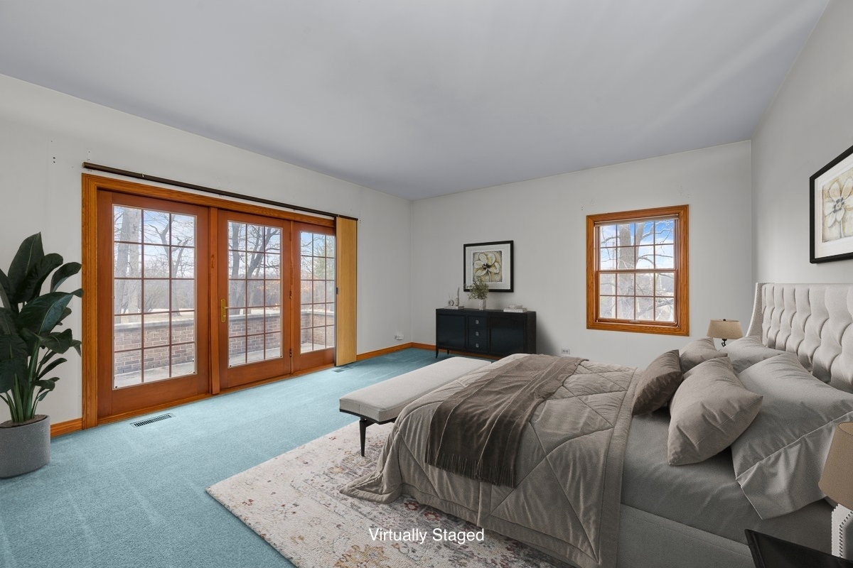 32981 North River Road Libertyville, IL 60048 - Photo 25 of 44 a spacious bedroom with a bed and a large window
