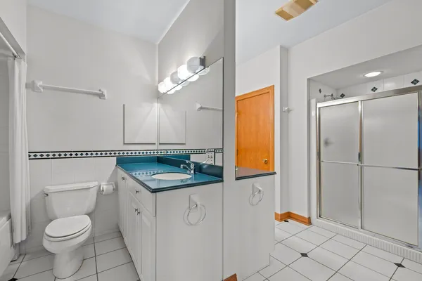 a hallway with white cabinets and sink