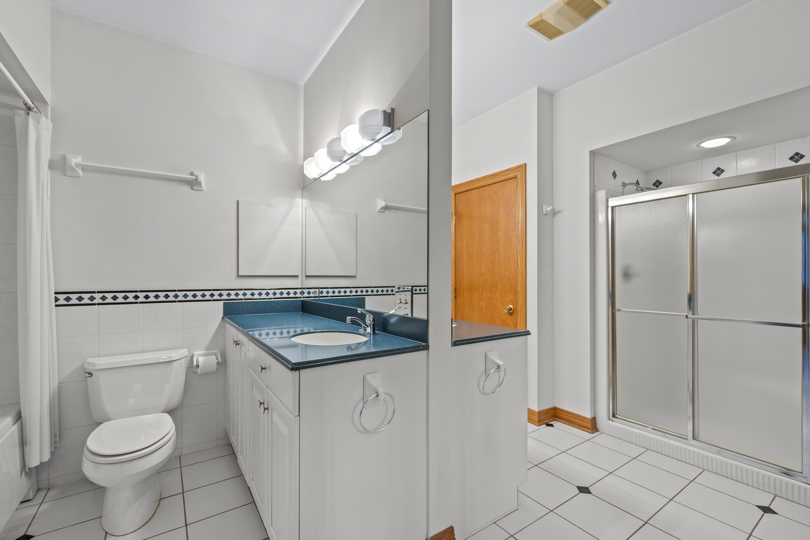 32981 North River Road Libertyville, IL 60048 - Photo 26 of 44 a bathroom with a granite countertop sink toilet and a mirror
