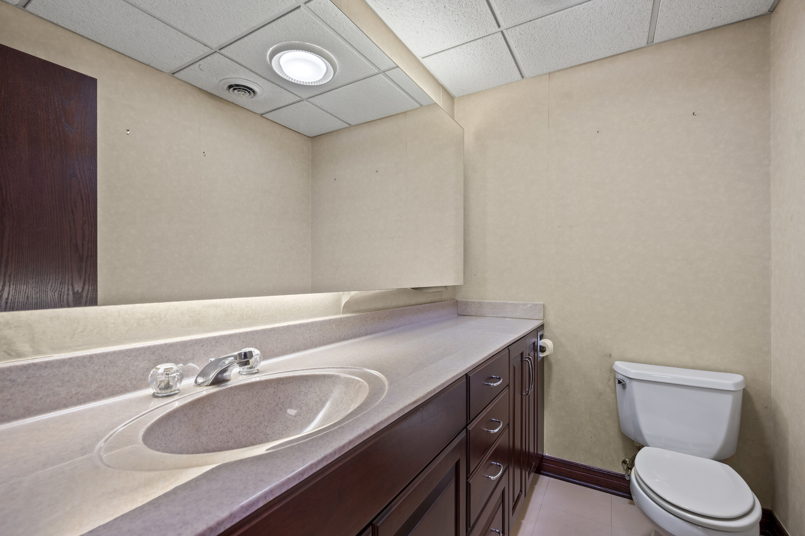 32981 North River Road Libertyville, IL 60048 - Photo 39 of 44 a bathroom with a granite countertop sink a toilet and a mirror