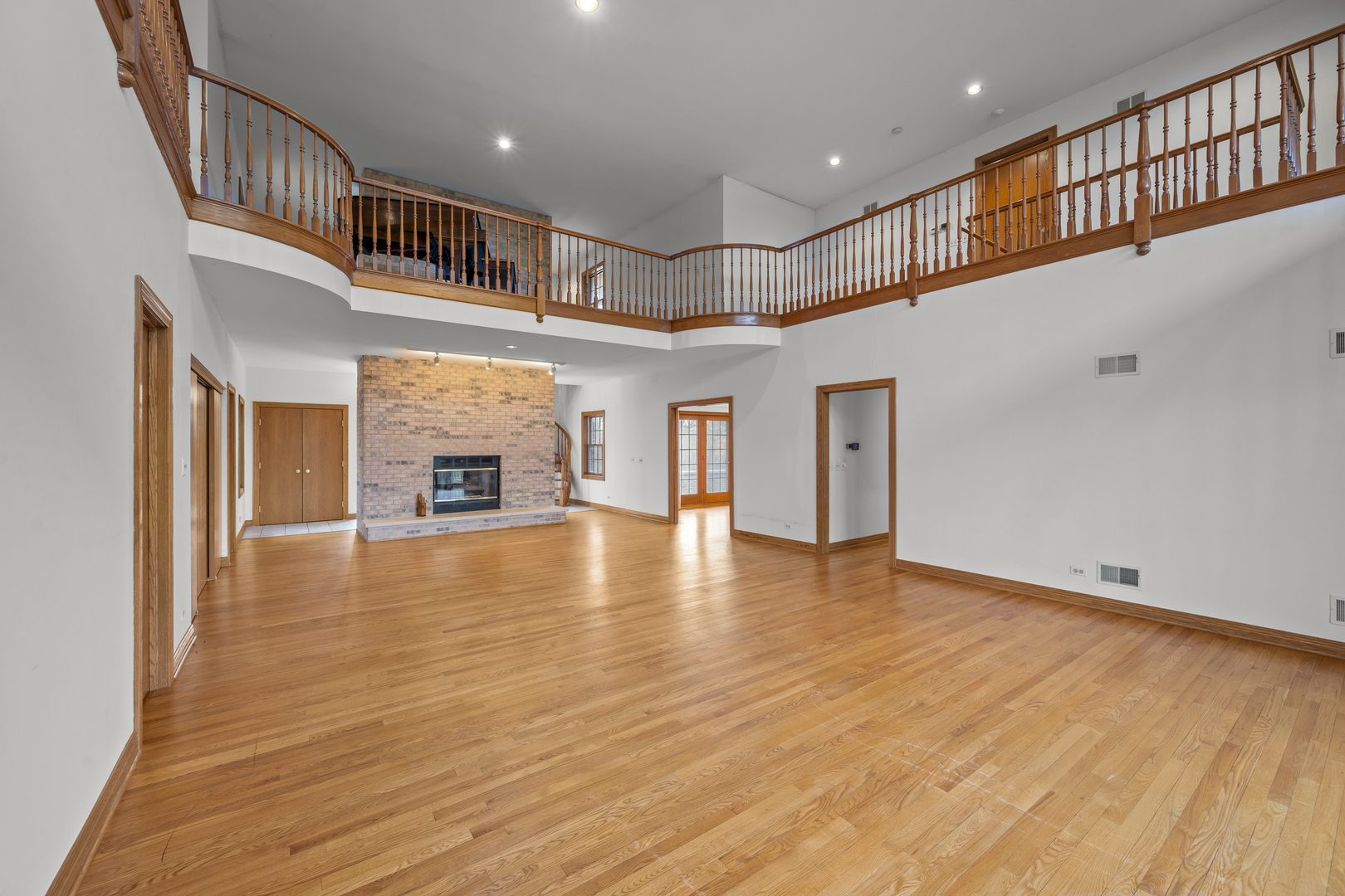 32981 North River Road Libertyville, IL 60048 - Photo 9 of 44 an empty room with wooden floor fireplace and windows