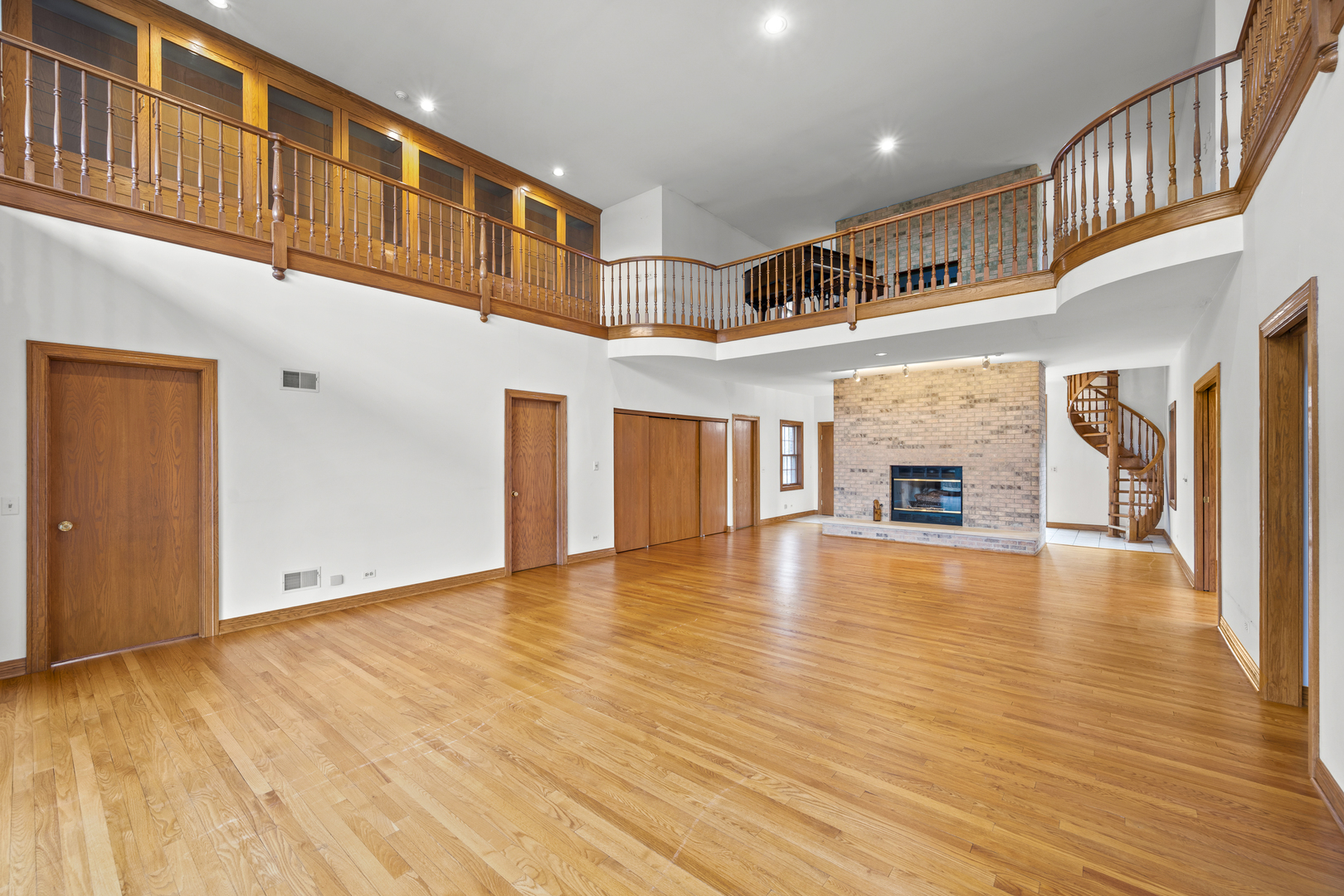 32981 North River Road Libertyville, IL 60048 - Photo 10 of 44 a view of an empty room with wooden floor and a fireplace