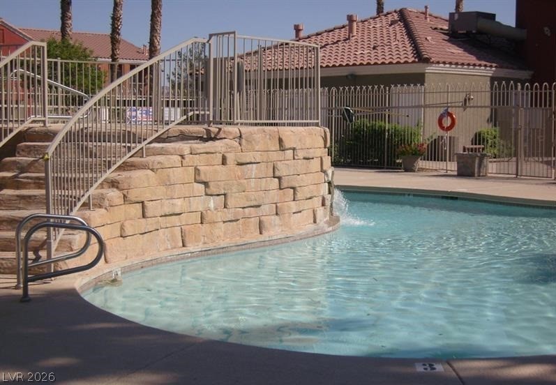 4730 East Craig Road, Unit 2102 Las Vegas, NV 89115 - Photo 5 of 13 A refreshing pool awaits, complete with a stone waterfall and convenient access stairs.