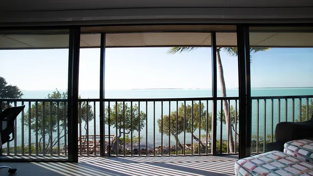a bathroom with a sink a mirror and a picture on the wall