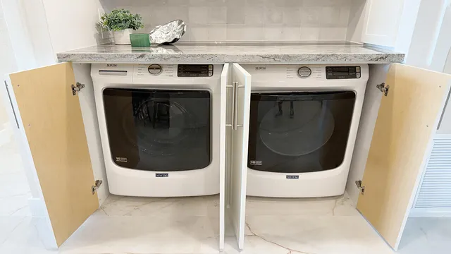 a view of a tennis court with lots of trees in the background