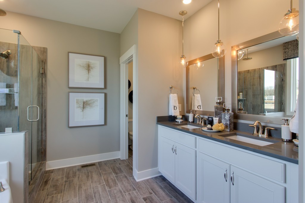 1715 Merkel Road West Columbia, TN 38401 - Photo 23 of 70 a bathroom with a double vanity sink a mirror and a shower