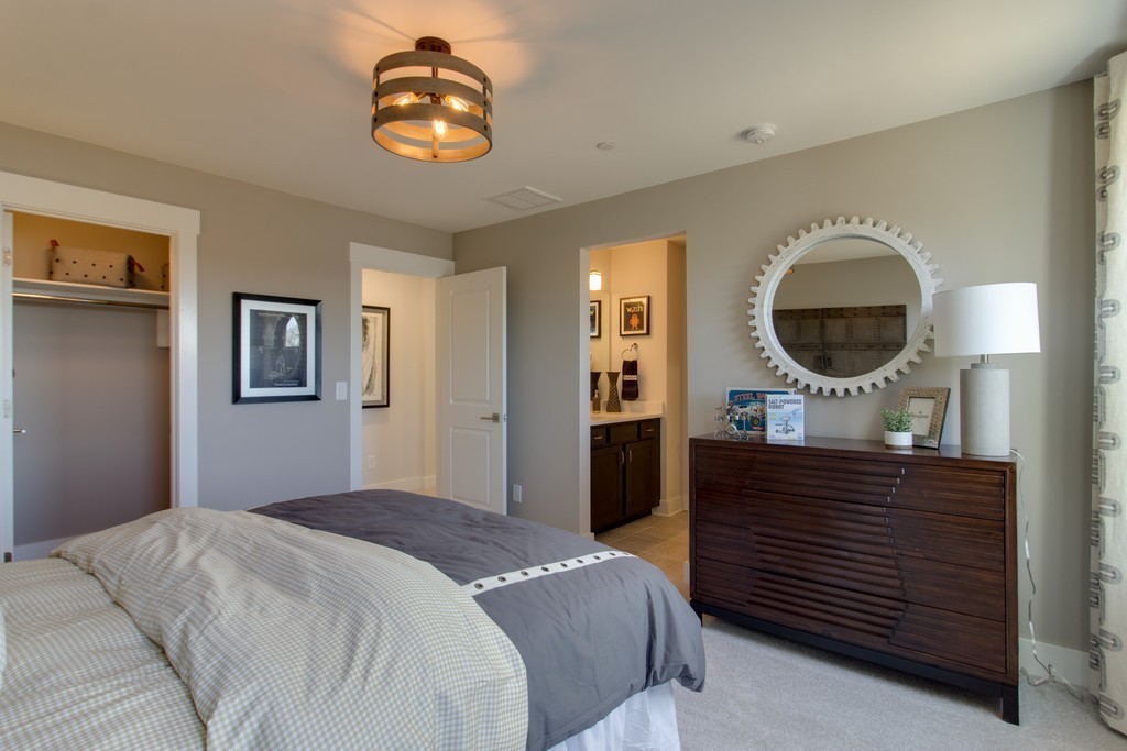 1715 Merkel Road West Columbia, TN 38401 - Photo 41 of 70 a bedroom with a bed and a chandelier