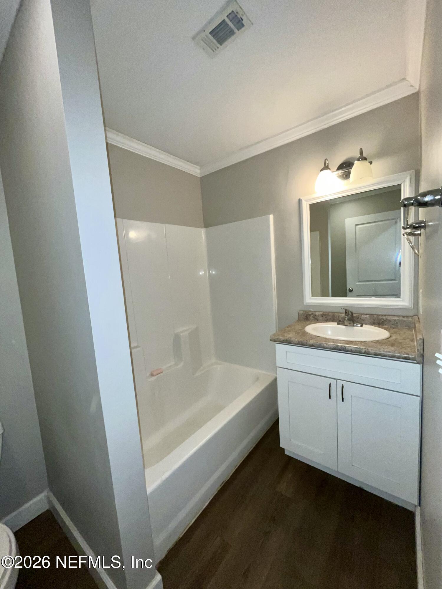 2017 Talladega Road Jacksonville, FL 32209 - Photo 24 of 34 a bathroom with a sink a toilet a mirror and shower