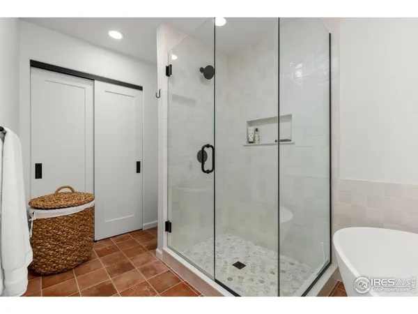 a bathroom with a granite countertop sink mirror and bathtub