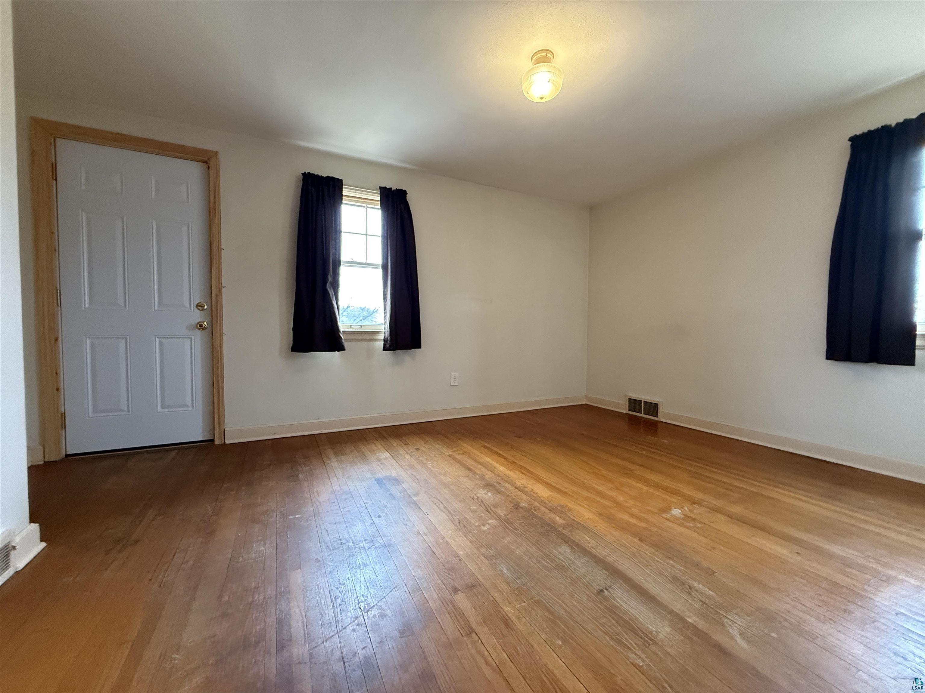 3001 3rd Avenue West Hibbing, MN 55746 - Photo 28 of 38 Spare room featuring light wood-type flooring and baseboards