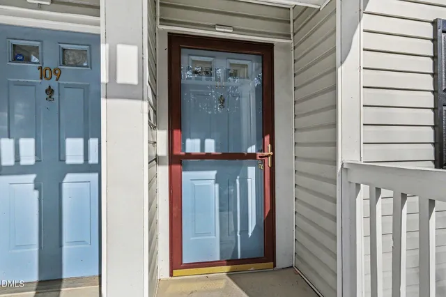 a view of a house with a large space and a car parked in front of it