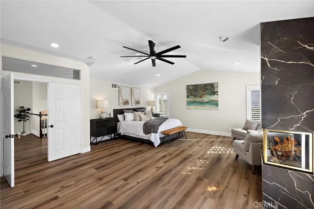 a living room with furniture a flat screen tv and a large window