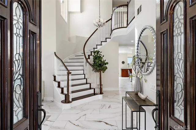 a living room with fireplace furniture and a large window