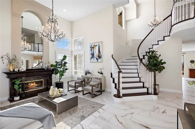 a view of a dining room with furniture and chandelier