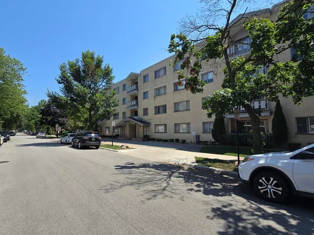 a view of a tall building next to a road