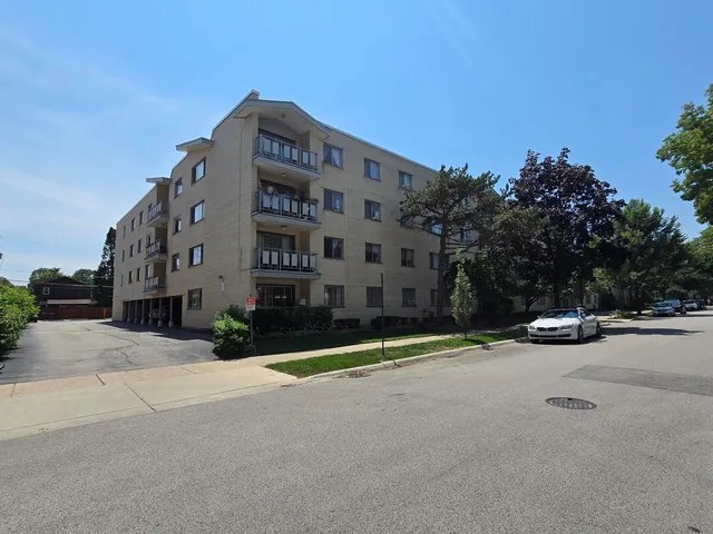 a view of a tall building next to a road