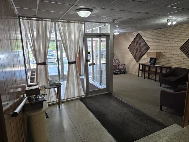 a buildings with car parked in front of it