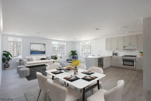 a living room with furniture kitchen view and a potted plant