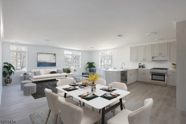 a living room with furniture kitchen view and a potted plant