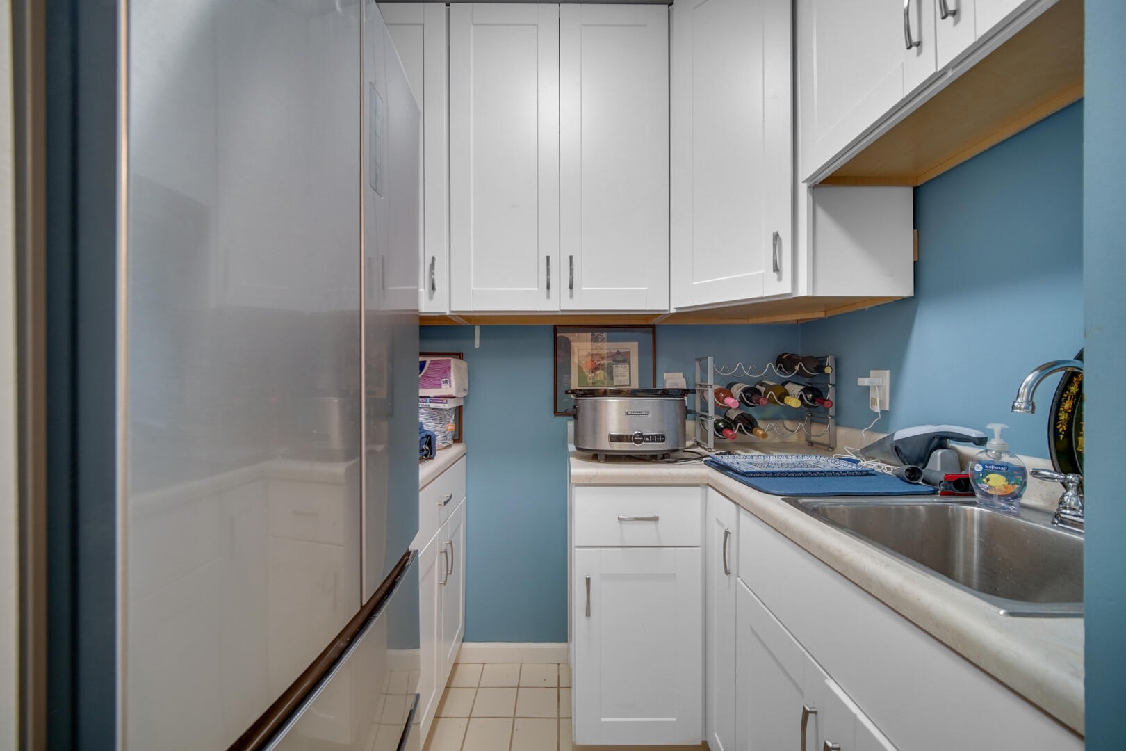 910 Ridge Road, Unit 405 Munster, IN 46321 - Photo 24 of 37 a kitchen with stainless steel appliances granite countertop a sink dishwasher and cabinets with wooden floor