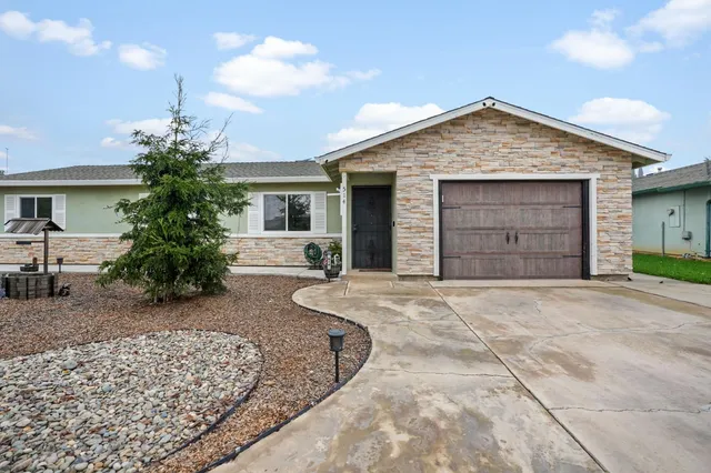 a front view of a house with a yard and garage