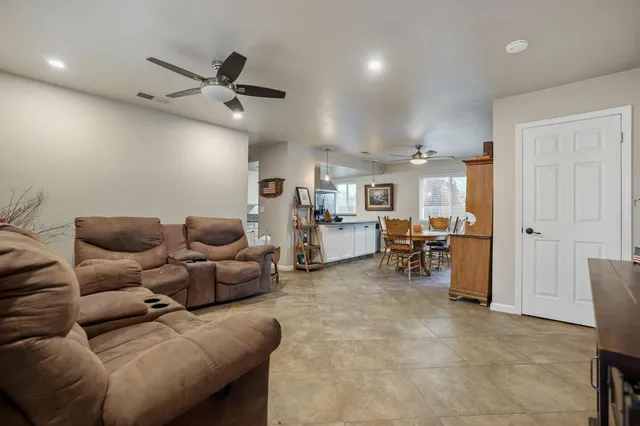 a living room with furniture and kitchen view