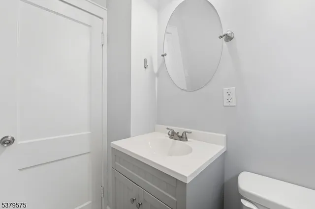 a bathroom with a sink a toilet and a mirror