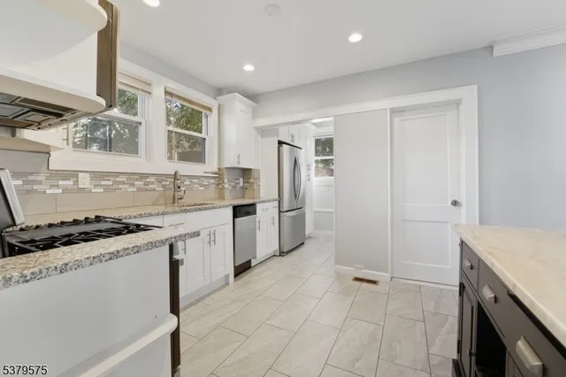 a kitchen with a sink stove and refrigerator