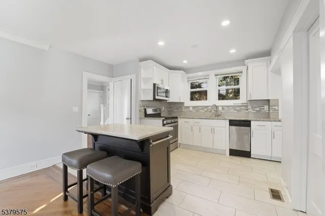 a kitchen with a sink cabinets and wooden floor