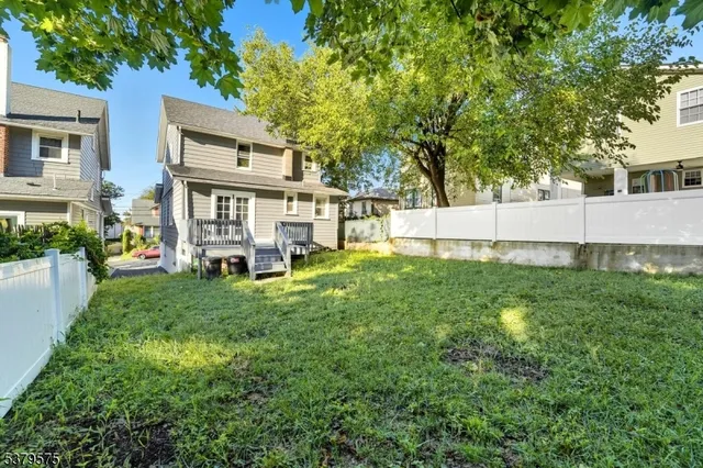 a view of a house with a yard and sitting area