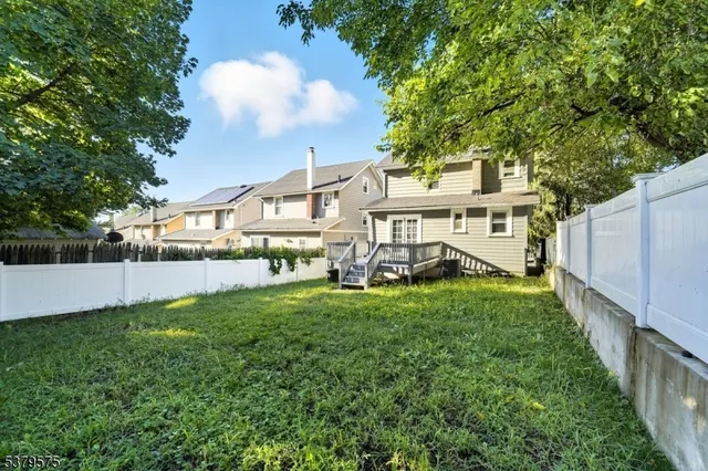 a view of a house with backyard and porch