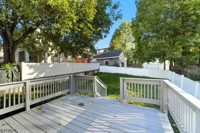 a view of a wooden deck and a yard