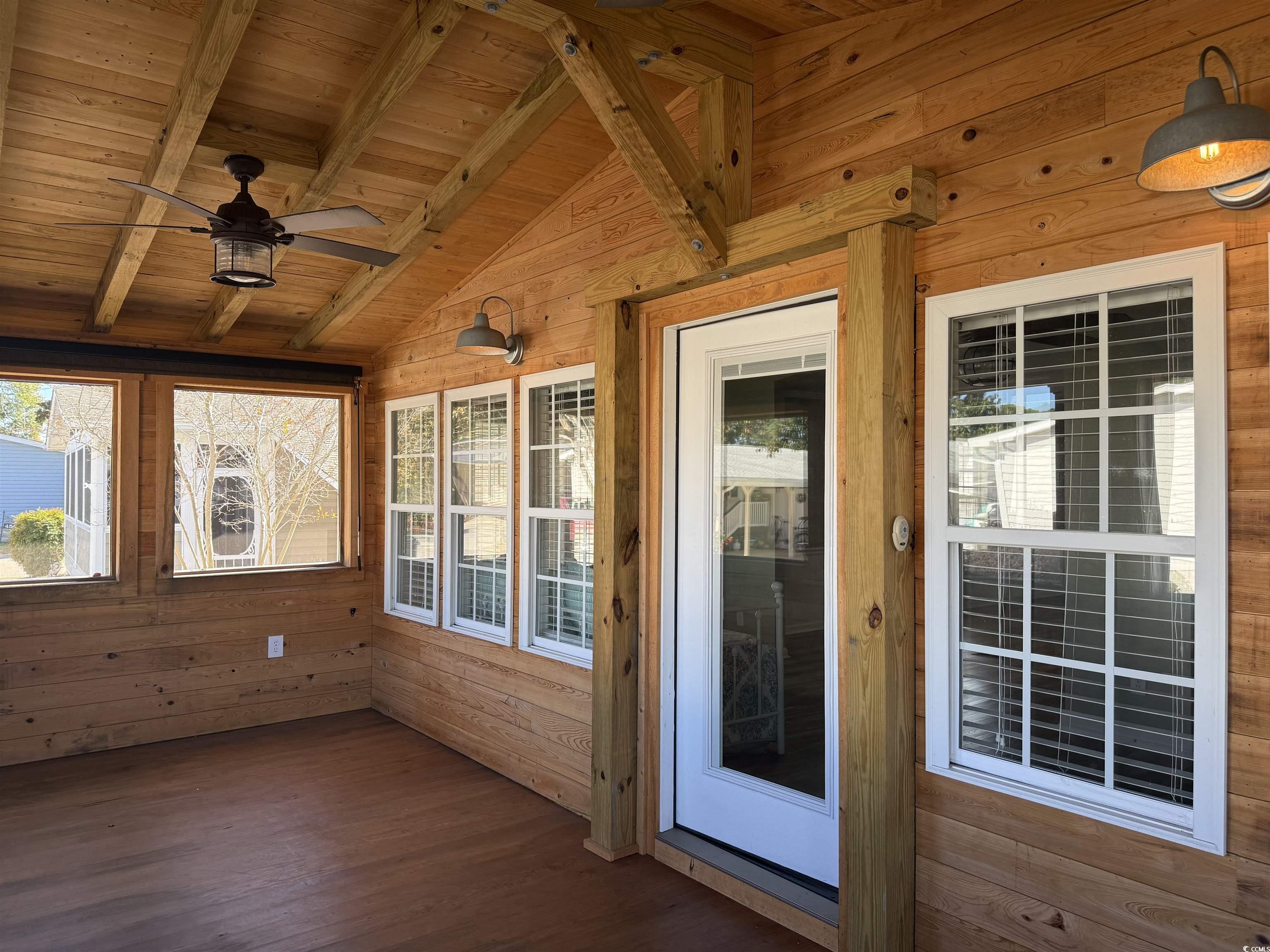 465 Sandpebble Surfside Beach, SC 29575 - Photo 22 of 40 Unfurnished sunroom with wooden ceiling, wooden walls, and wood finished floors