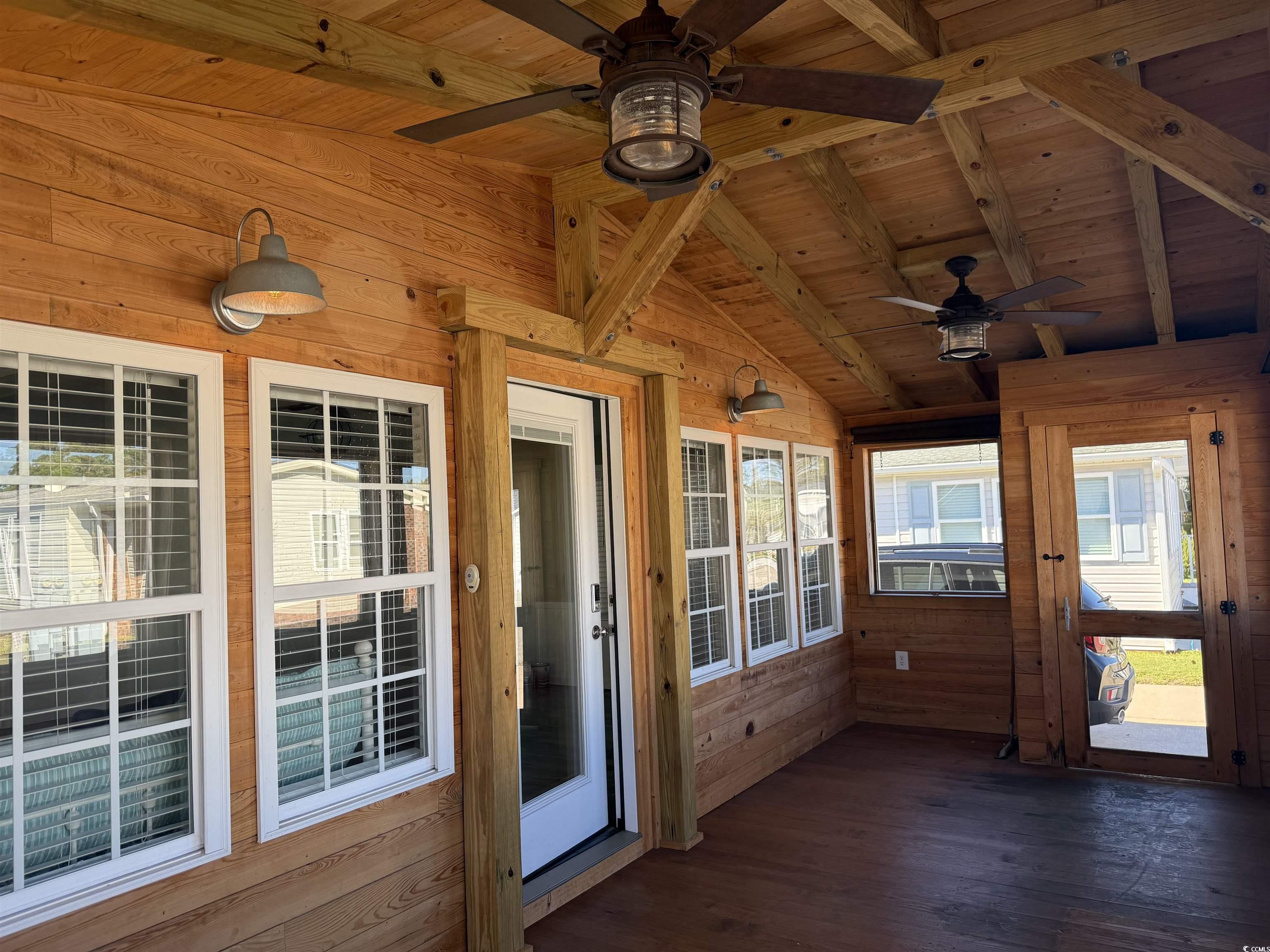 465 Sandpebble Surfside Beach, SC 29575 - Photo 23 of 40 Unfurnished sunroom with wooden walls, wood ceiling, ceiling fan, and hardwood / wood-style flooring