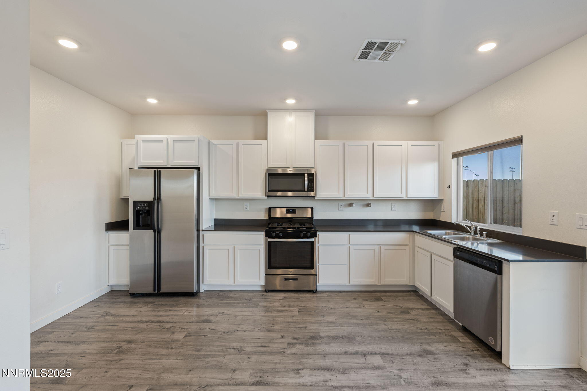 8791 Portia Drive Reno, NV 89506 - Photo 11 of 28 a large kitchen with stainless steel appliances granite countertop a stove and a refrigerator