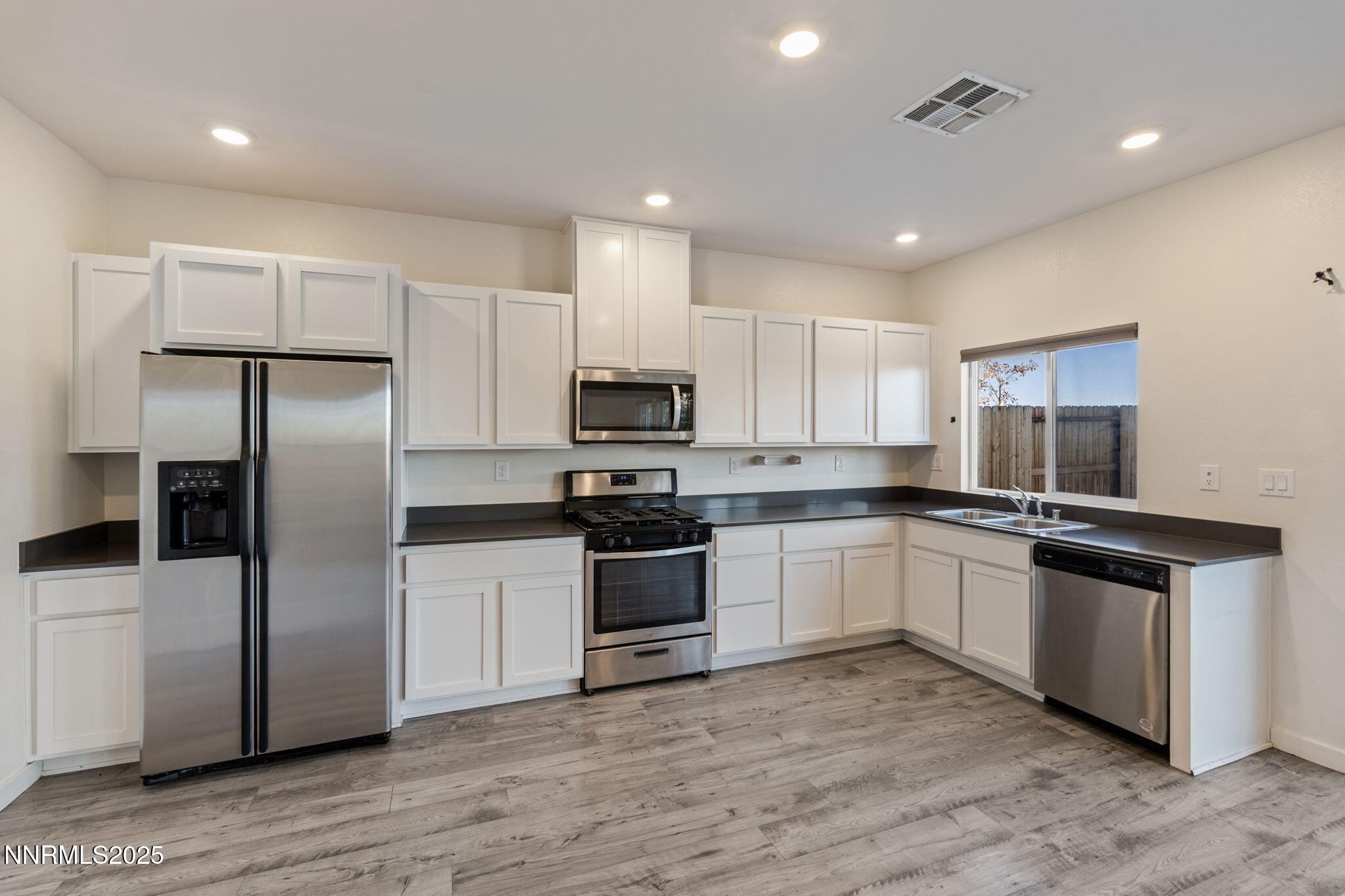 8791 Portia Drive Reno, NV 89506 - Photo 12 of 28 a kitchen with stainless steel appliances granite countertop a refrigerator a sink and a stove