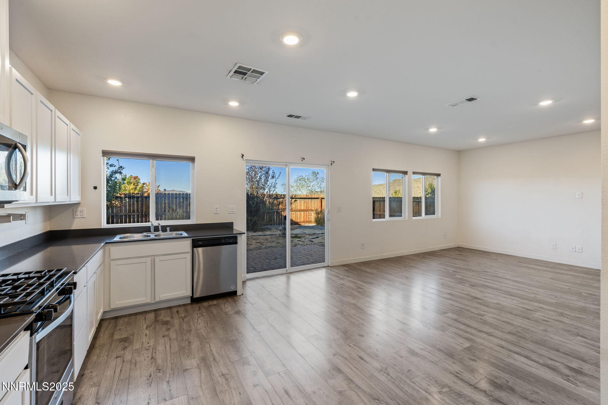 8791 Portia Drive Reno, NV 89506 - Photo 14 of 28 a large kitchen with a wooden floor and stainless steel appliances