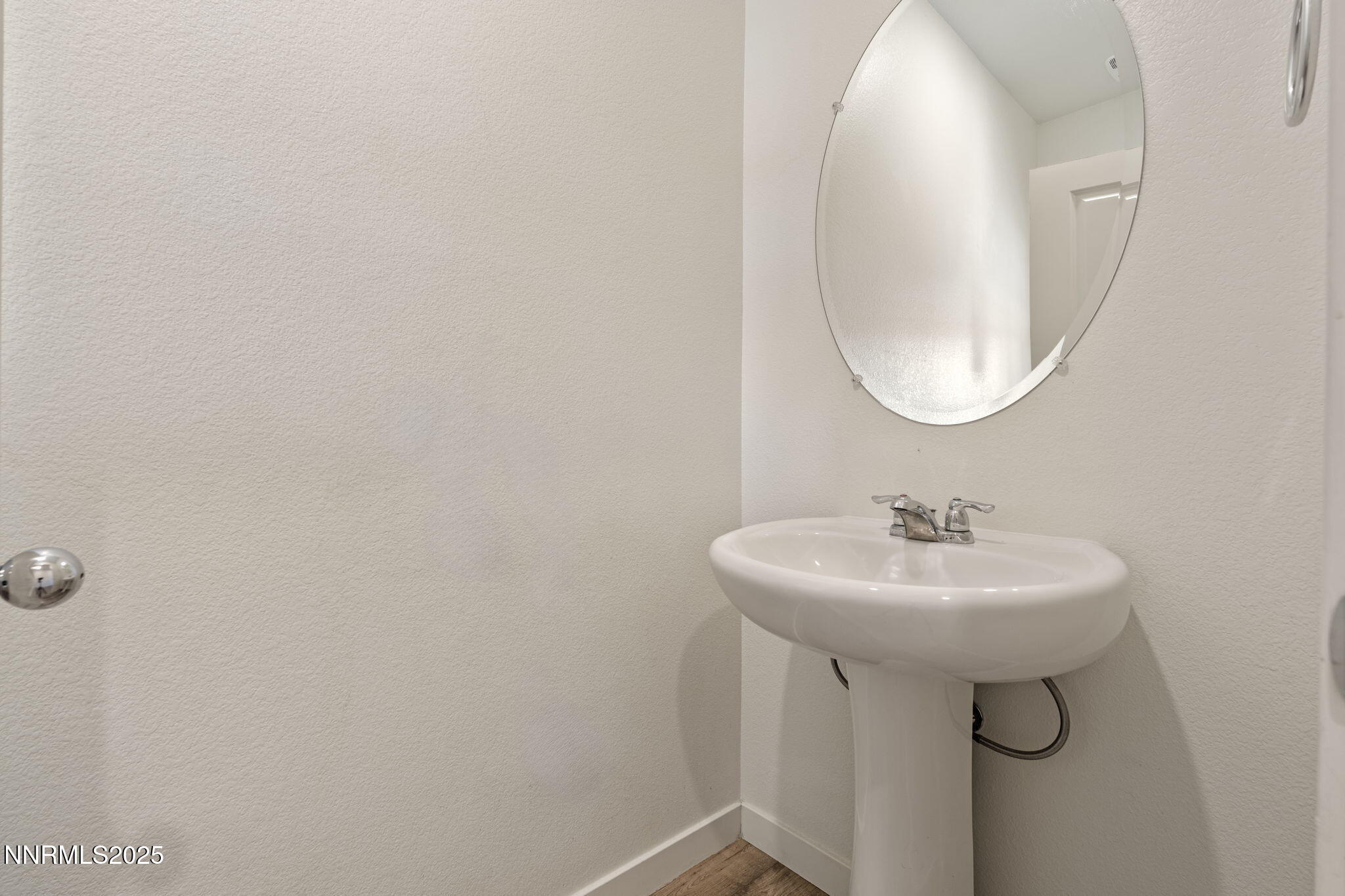 8791 Portia Drive Reno, NV 89506 - Photo 15 of 28 a bathroom with a sink a mirror and a window