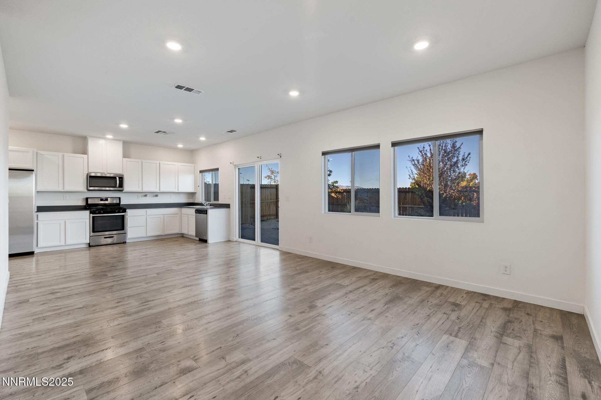 8791 Portia Drive Reno, NV 89506 - Photo 4 of 28 a view of an empty room and kitchen with a window