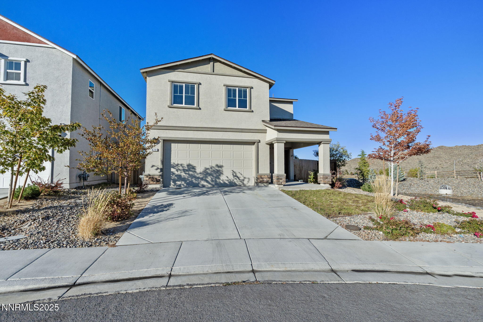 8791 Portia Drive Reno, NV 89506 - Photo 5 of 28 a front view of a house with a yard