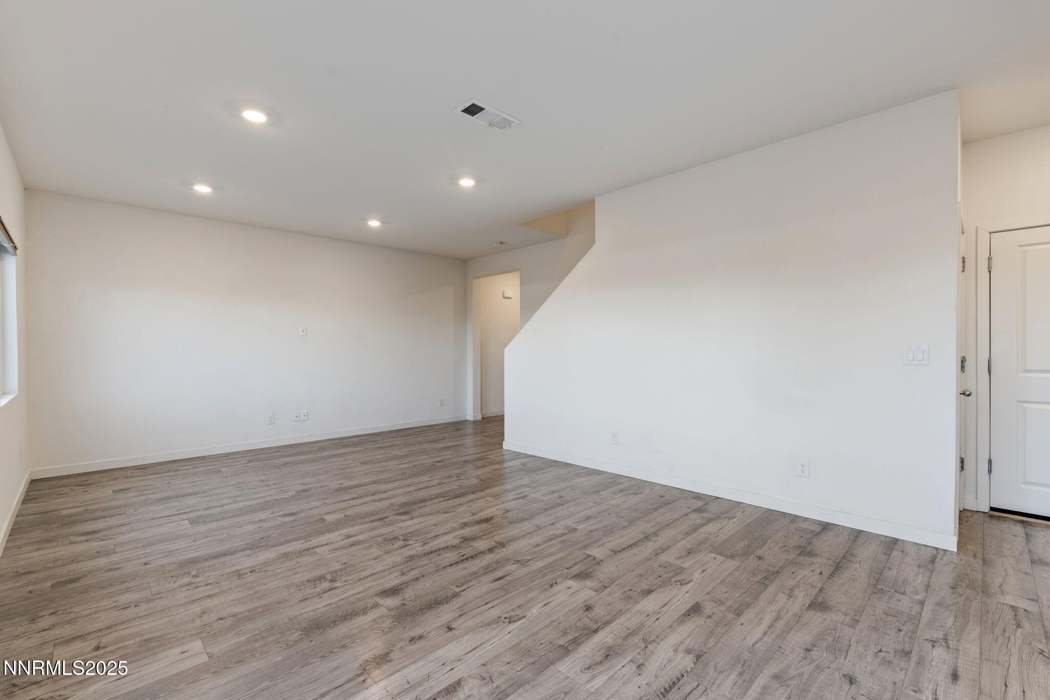 8791 Portia Drive Reno, NV 89506 - Photo 7 of 28 a view of an empty room with wooden floor