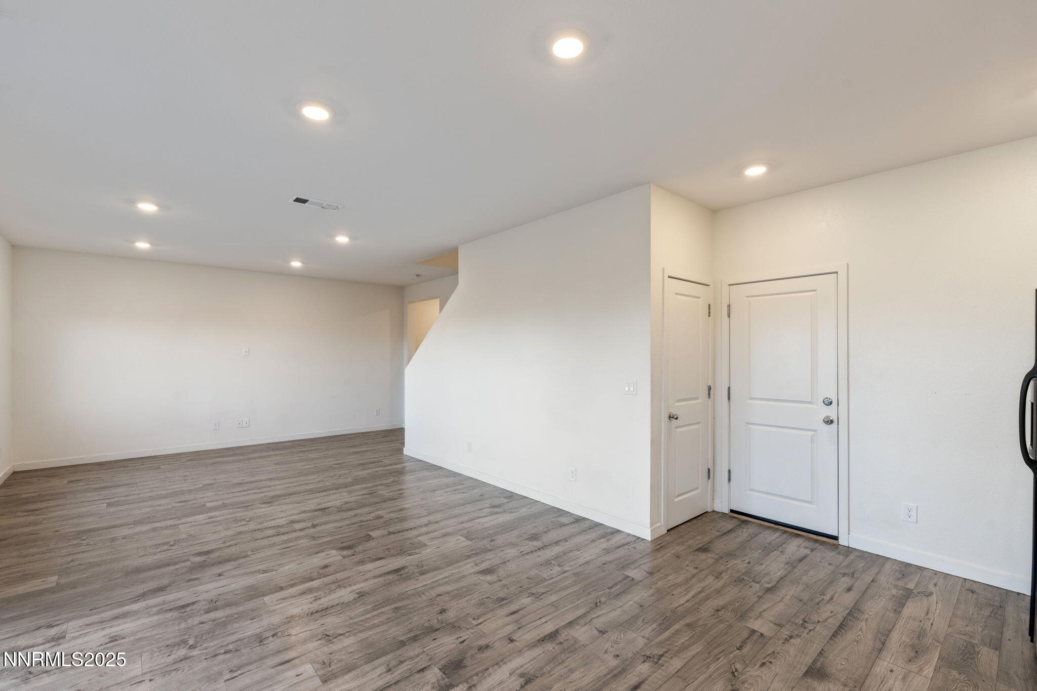 8791 Portia Drive Reno, NV 89506 - Photo 8 of 28 a view of an empty room with wooden floor