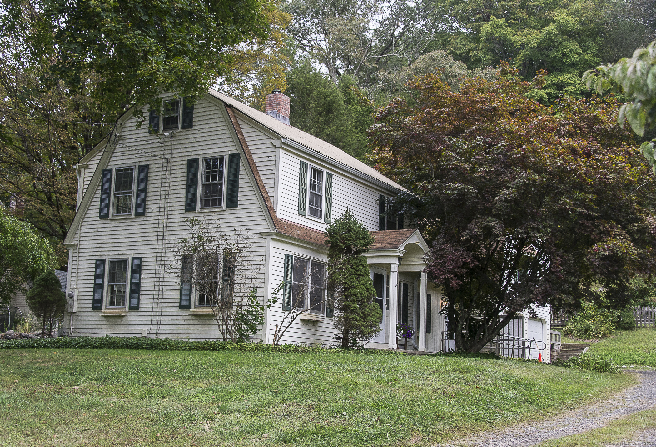a front view of a house with a garden and yard