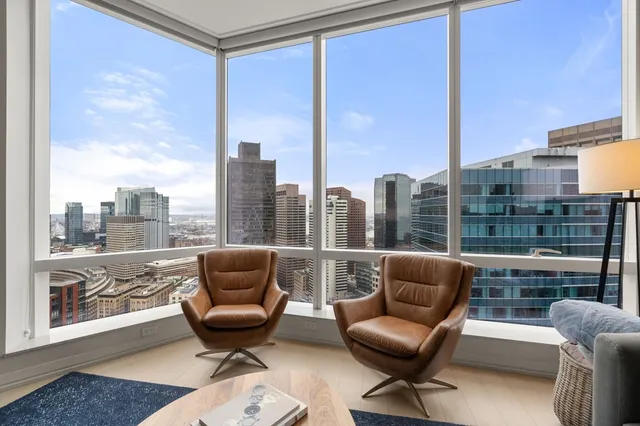 a kitchen with stainless steel appliances a stove a sink a kitchen island with a dining table and chairs