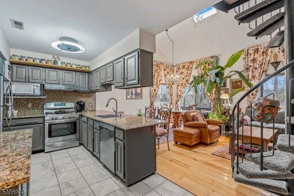 a kitchen with stainless steel appliances granite countertop a stove and a sink