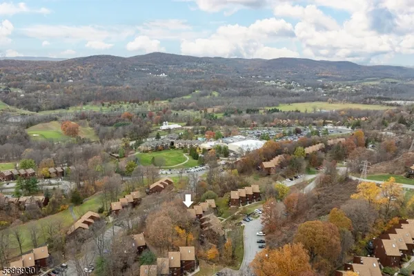 an aerial view of a house with a swimming pool