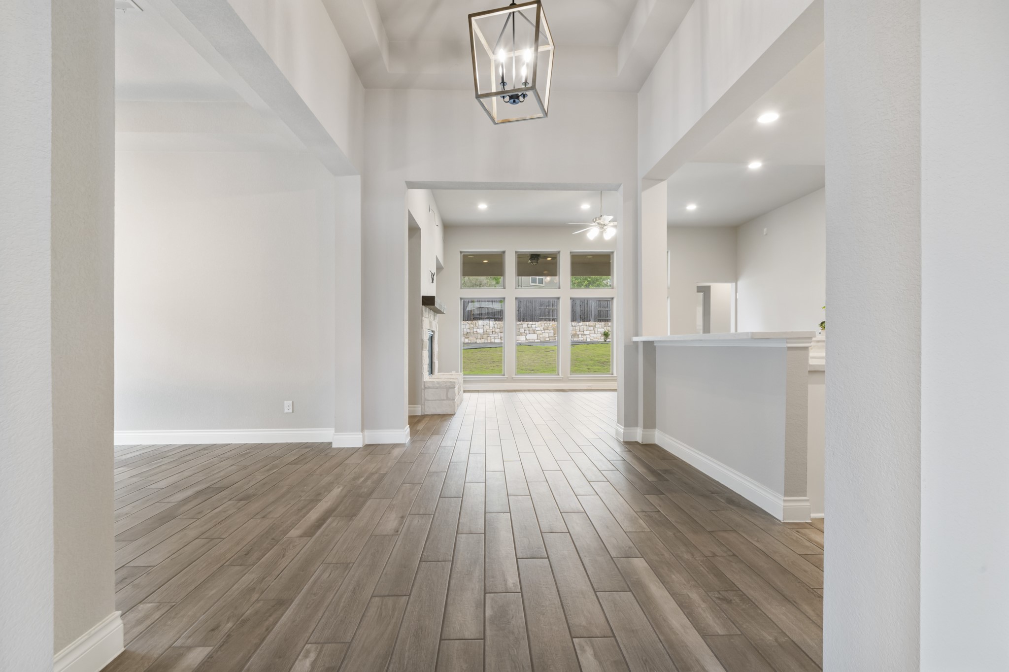 104 Catani Loop Georgetown, TX 78628 - Photo 22 of 34 Entryway featuring wood plank flooring, light-colored walls, recessed lighting, and a modern style hanging light fixture