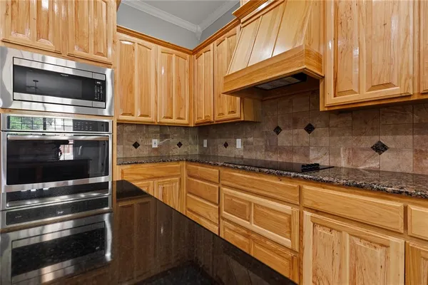 a kitchen with granite countertop cabinets stainless steel appliances and a sink