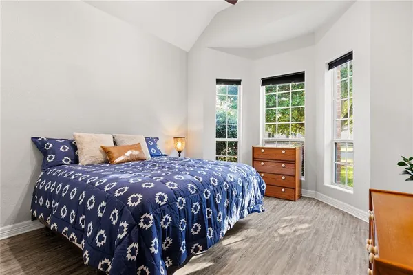 a bedroom with a bed next to a window